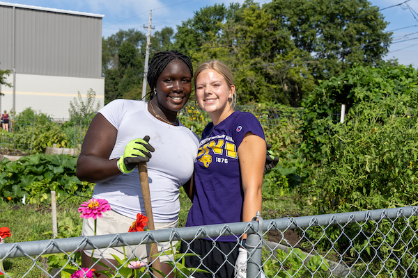 Two students working in the Panther garden.