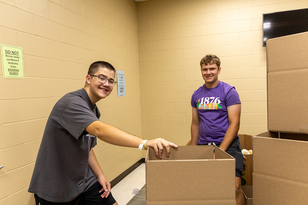 Two students volunteering at the food bank.