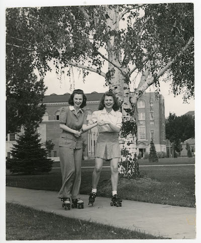 Photo of two students roller skating on campus from the 1940s or 1950s.