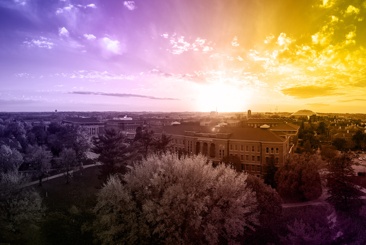 Drone shot of campus with purple and gold overlay